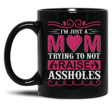I'M Just A Mom Trying To Not Raise Assholes Black Coffee Mug