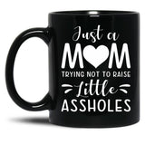 Just A Mom Trying Not To Raise Little Assholes Black Coffee Mug